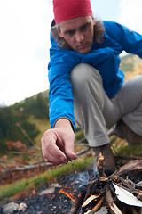 Image showing hiking man try to light fire