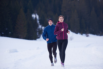 Image showing couple jogging outside on snow