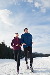 Image showing couple jogging outside on snow