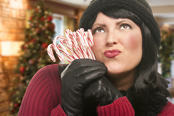 Image showing Woman Holding Candy Canes in Christmas Setting