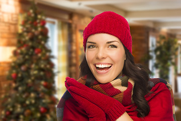 Image showing Mixed Race Woman Wearing Mittens and Hat In Christmas Setting