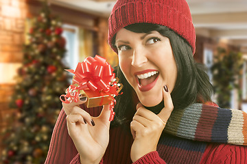 Image showing Woman Holding Wrapped Gift in Christmas Setting