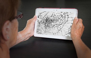 Image showing Senior lady with tablet, cracked screen