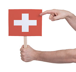 Image showing Hand holding small card - Flag of Switzerland