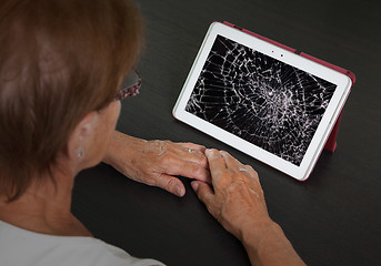 Image showing Senior lady with tablet, cracked screen