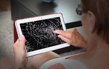 Image showing Senior lady with tablet, cracked screen