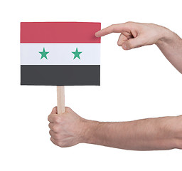 Image showing Hand holding small card - Flag of Syria