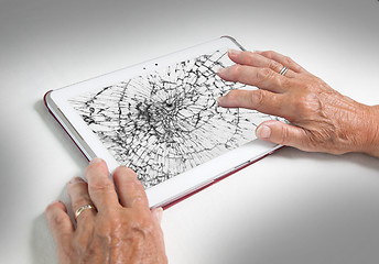 Image showing Senior lady with tablet, cracked screen