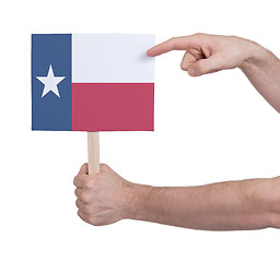 Image showing Hand holding small card - Flag of Texas