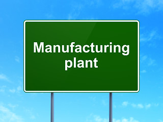 Image showing Manufacuring concept: Manufacturing Plant on road sign background