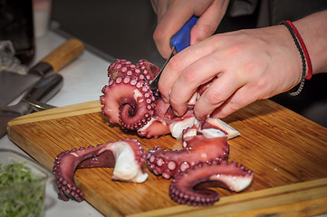 Image showing chef cutting octopus 