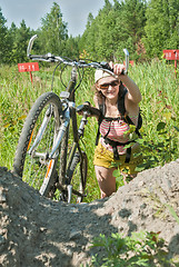 Image showing Happy young woman with bicycle