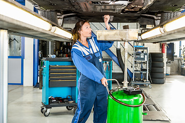 Image showing Mechanic Repairing Car On Hydraulic Lift