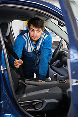 Image showing Portrait Of Mechanic Examining Car Seat Belt