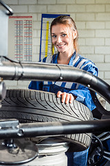 Image showing Mechanics Using Digital Tablet In Car At Garage