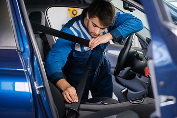 Image showing Mechanic Examining Car Seat Belt