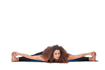 Image showing Studio shot of a young fit woman doing yoga exercises.