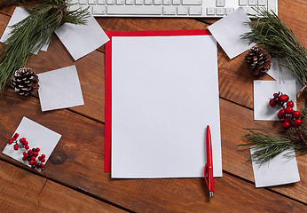 Image showing The blank sheet of paper on the wooden table with a pen 