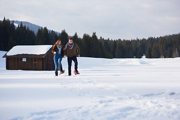 Image showing couple having fun and walking in snow shoes