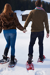 Image showing couple having fun and walking in snow shoes