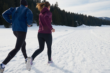 Image showing couple jogging outside on snow