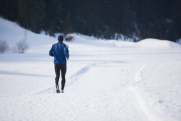 Image showing jogging on snow in forest