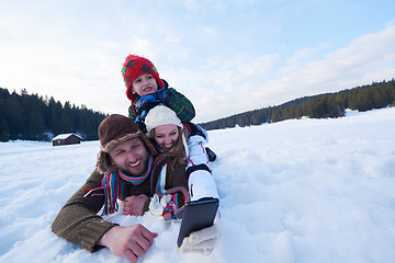 Image showing romantic couple have fun in fresh snow and taking selfie