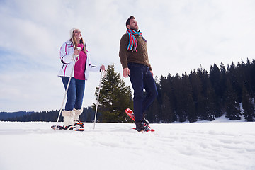 Image showing couple having fun and walking in snow shoes