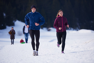 Image showing couple jogging outside on snow