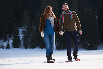 Image showing couple having fun and walking in snow shoes