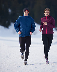 Image showing couple jogging outside on snow