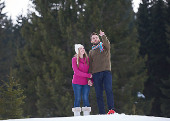 Image showing couple having fun and walking in snow shoes