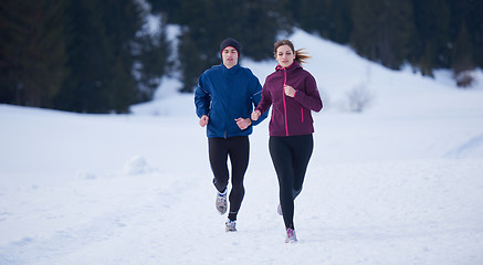 Image showing couple jogging outside on snow