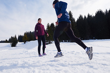 Image showing couple jogging outside on snow