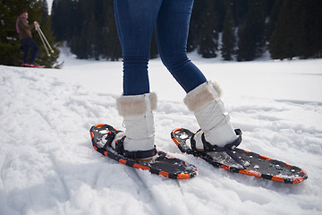 Image showing couple having fun and walking in snow shoes