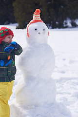 Image showing boy making snowman