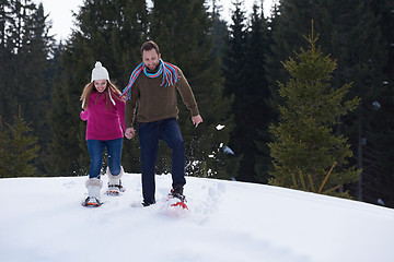 Image showing couple having fun and walking in snow shoes