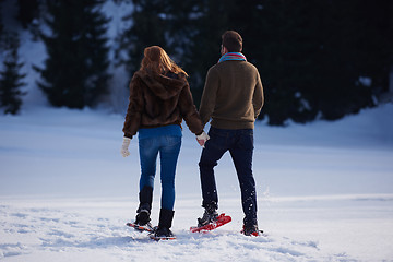 Image showing couple having fun and walking in snow shoes