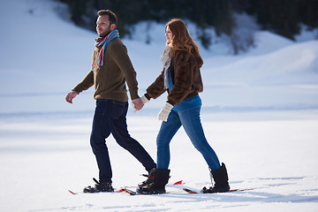 Image showing couple having fun and walking in snow shoes