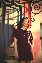 Image showing beautiful middle-aged woman near the ancient door