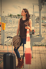 Image showing woman with luggage is waiting for permission to pass through the