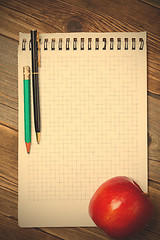 Image showing scratchpad for taking notes, a pen, a pencil and an apple