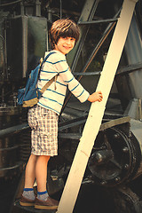 Image showing child-researcher on the stairs of an old steam locomotive