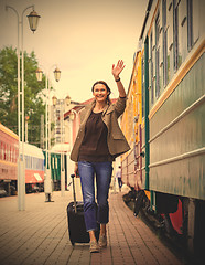 Image showing smiling pretty middle-aged woman goes in a retro trip