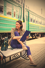 Image showing beautiful middle-aged woman traveler on a railway station