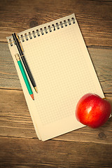 Image showing still life with notebook and apple