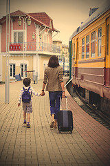 Image showing Mother and son goes on the landside platform