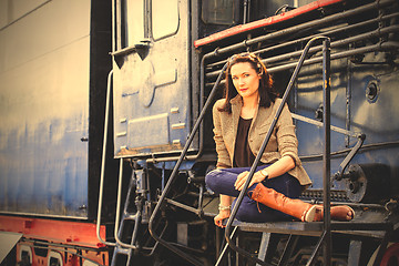 Image showing beautiful woman near an old steam locomotive