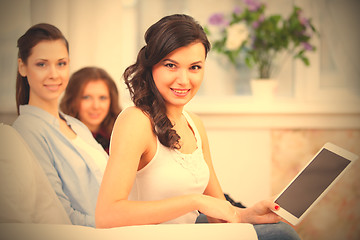 Image showing three smiling young girls with tablet