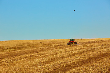 Image showing Agricultural Landscape. Tractor working on the field.